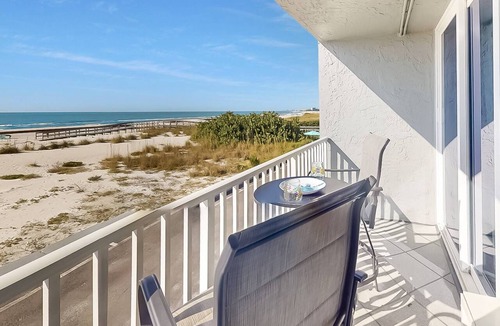 Treasure Island Condo | Beachfront Balcony ~ View of Treasure Island Beach ~ Heated Pool, Tiki Bar, BBQ Grills, Volleyball.