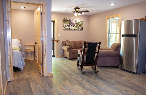 Carlisle Cabin | Cabin Bunkhouse with Hot Tub on Private Lake, Fire Pit & Swings in Vian, OK!