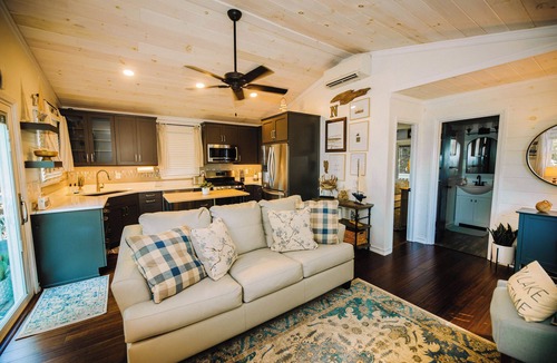 New River House | Charming lakeside retreat with serene views, cozy interiors, spacious deck, and lush outdoor spaces.