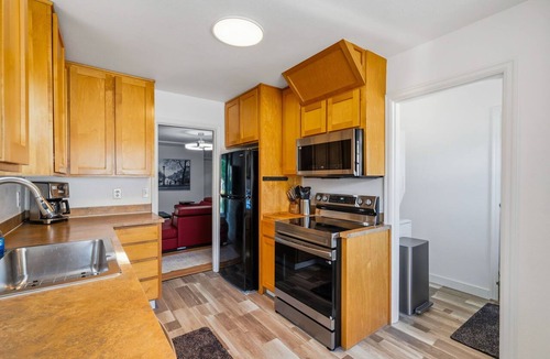 Downtown Vancouver House | Freshly renovated home with brand-new appliances, a new big-screen TV, refinished hardwood floors, and all-new furniture throughout. Sink into the plush leather sectional (pull-out queen sleeper) or dine at the six-seat table in the garden.