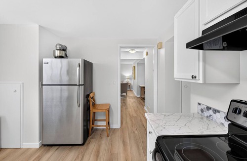 Central Okanagan House | Relax at a central Kelowna pool house with a private backyard oasis, outdoor bar & spacious layout over two levels. Walk or take a short drive to downtown cafés, shops, beaches & wineries, then come home to a quiet, stylish space.