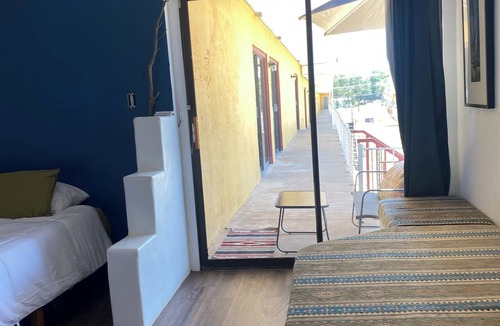 Tucumcari Hotel | Southwest adobe style bancos & faux kiva fireplace with RT 66 views. Walk to all