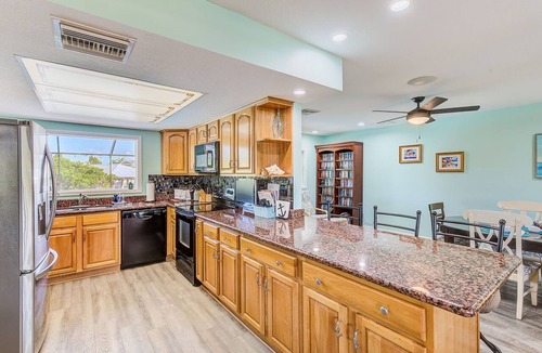 Apollo Beach House | Waterfront Oasis w/screened Lanai & Heated Pool, Private Dock + Kayaks 3BR/2BA