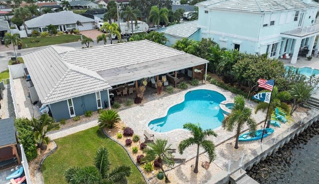 Amazing waterfront home with stunning sunset views, a heated pool & hot tub!