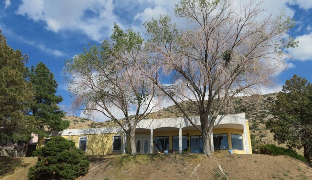 House against the Sandia mountains