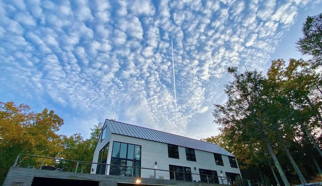 Modern waterfront home on a private peninsula, surrounded by stunning water views on three sides