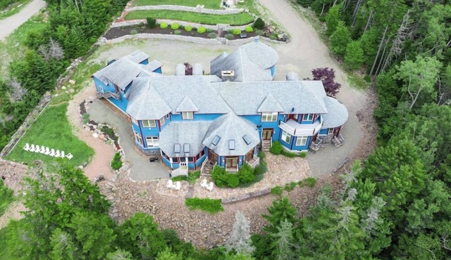 One-of-kind estate with unique & luxurious decor and wooded oceanside location.