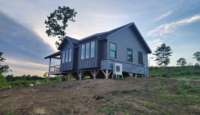 Small cottage house, centered on 100 acres surround by hills, lake, and cattle.