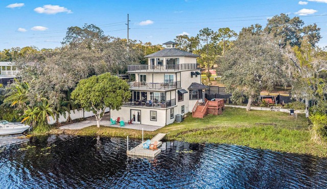 Sprawling river view estate with game room dock kayaks grill and fishing gear