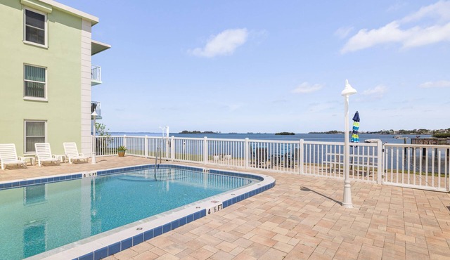 Waterfront Escape! Heated Pool, BBQ, Clubhouse & Pier – Dolphins & Sunsets from Your Private Porch!